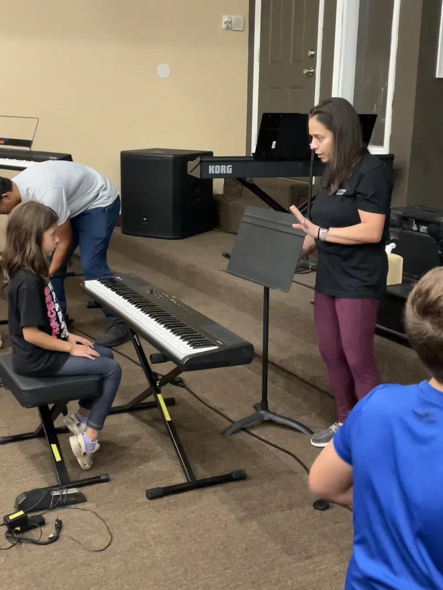 Student receiving guidance during a keyboard lesson