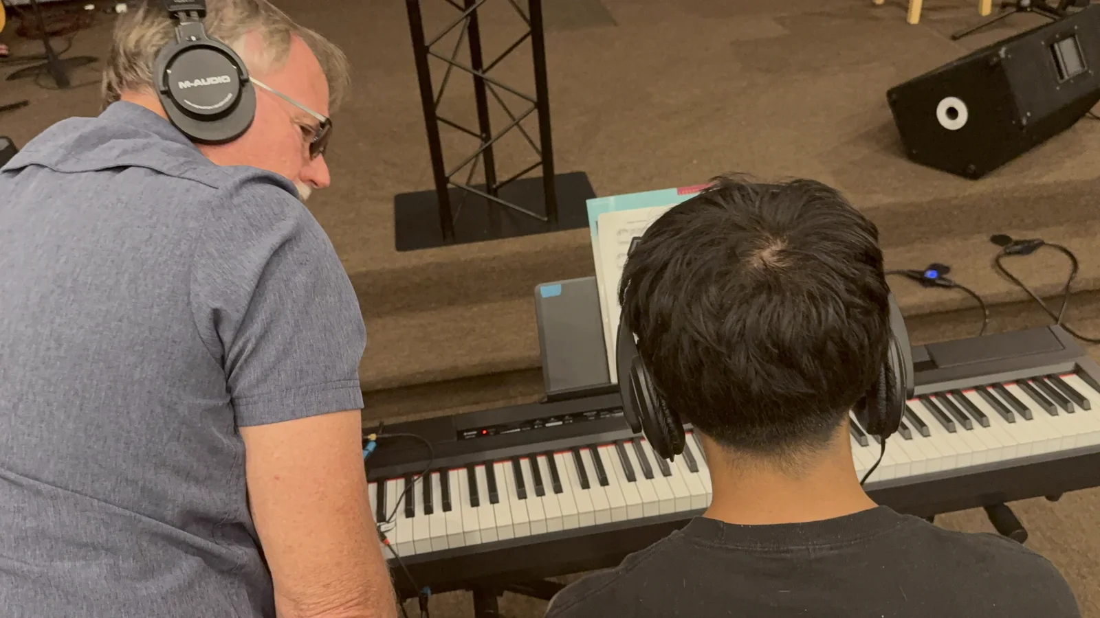Spark Academy instructor coaching a student at the keyboard